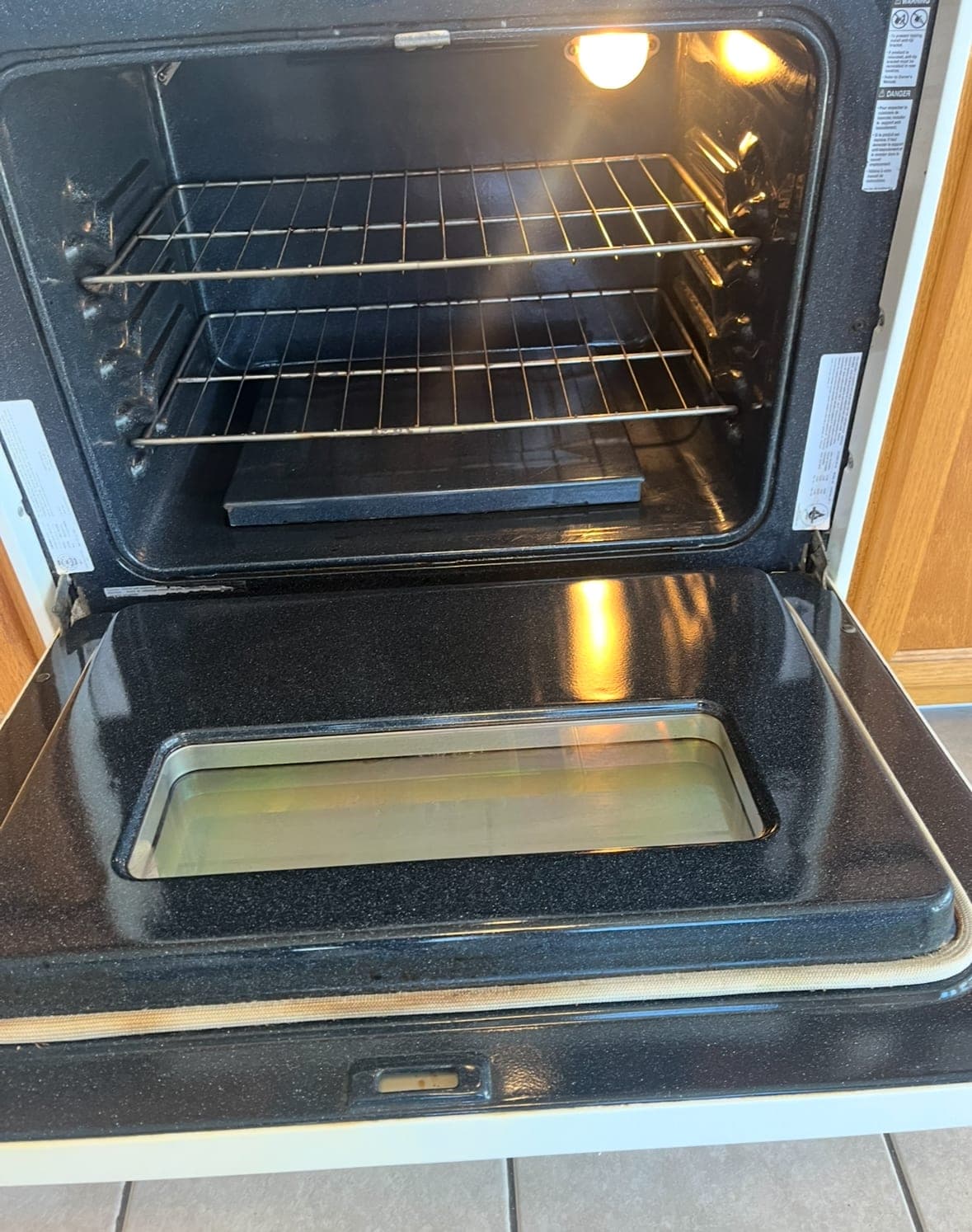 The same oven interior after cleaning, with clean racks and glass